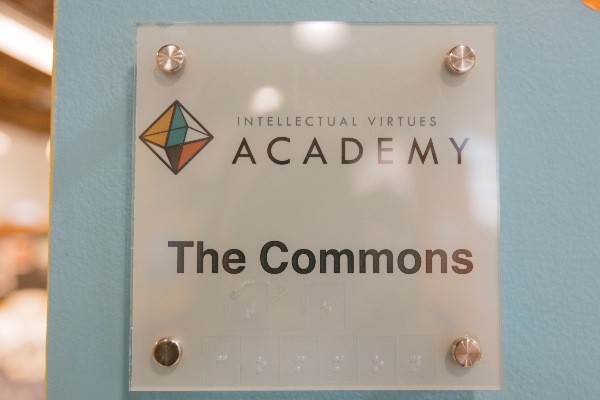 Sign outside door with text The Commons