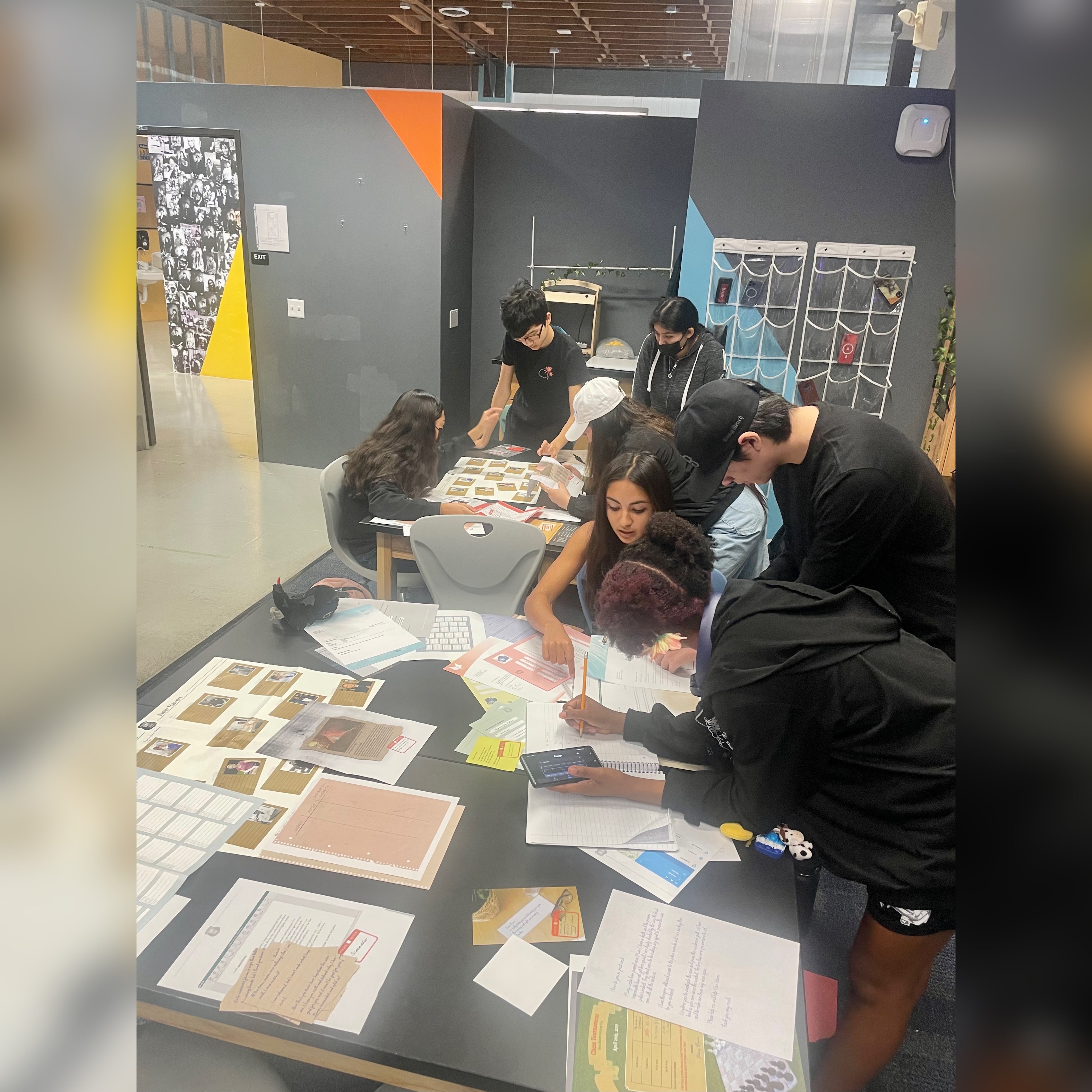 Students work together around a table on a project