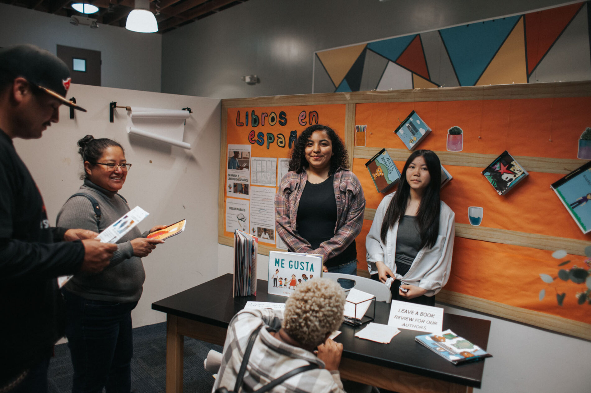Two students at IVA High stand behind a table to display a project.