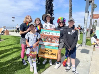 Marisol Marquez, Summer Sanders, and two young community members stand with students from IVA High’s GSA Club before marching on Ocean Blvd. in the Long Beach Pride Parade.