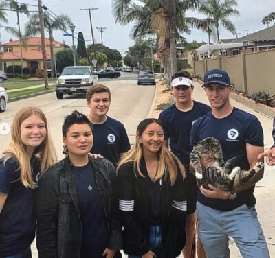 IVA High students pose with a cat for a photo during an internship with Animal Rescue.