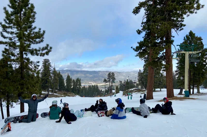 IVA High Students sit at the top of a run while snowboarding during a field trip. It’s a beautiful day on the mountain.