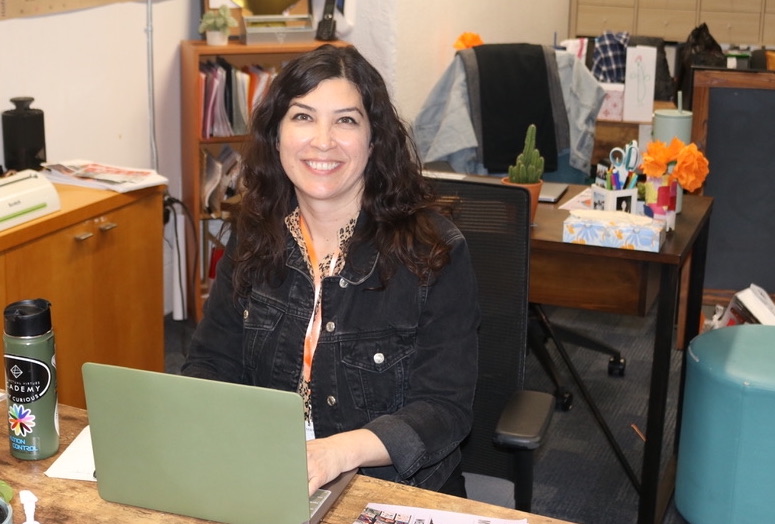 IVA High director sitting in front of a laptop