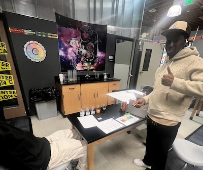 An IVA High student gives a thumbs up while showcasing his project during the Exhibition of Learning.