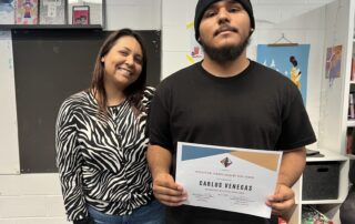 IVA High Counselor Darlin stands with a student who holds an award certificate