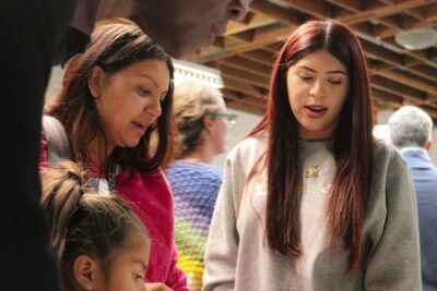 An IVA Student and parent discuss work.